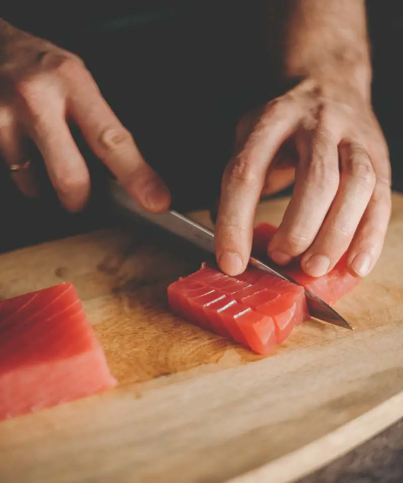 Chef cutting salmon